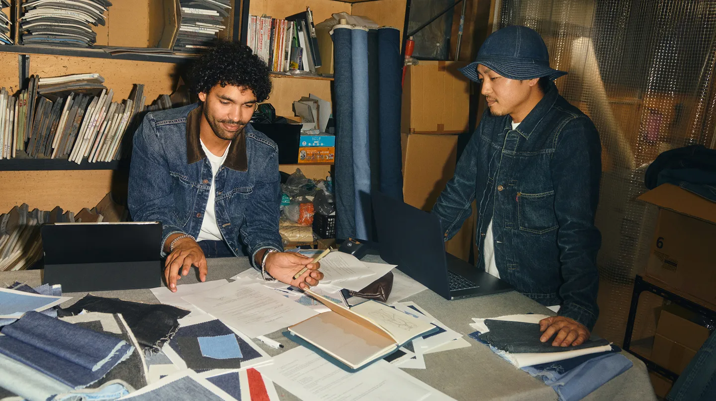Two men having a clothing design meeting
