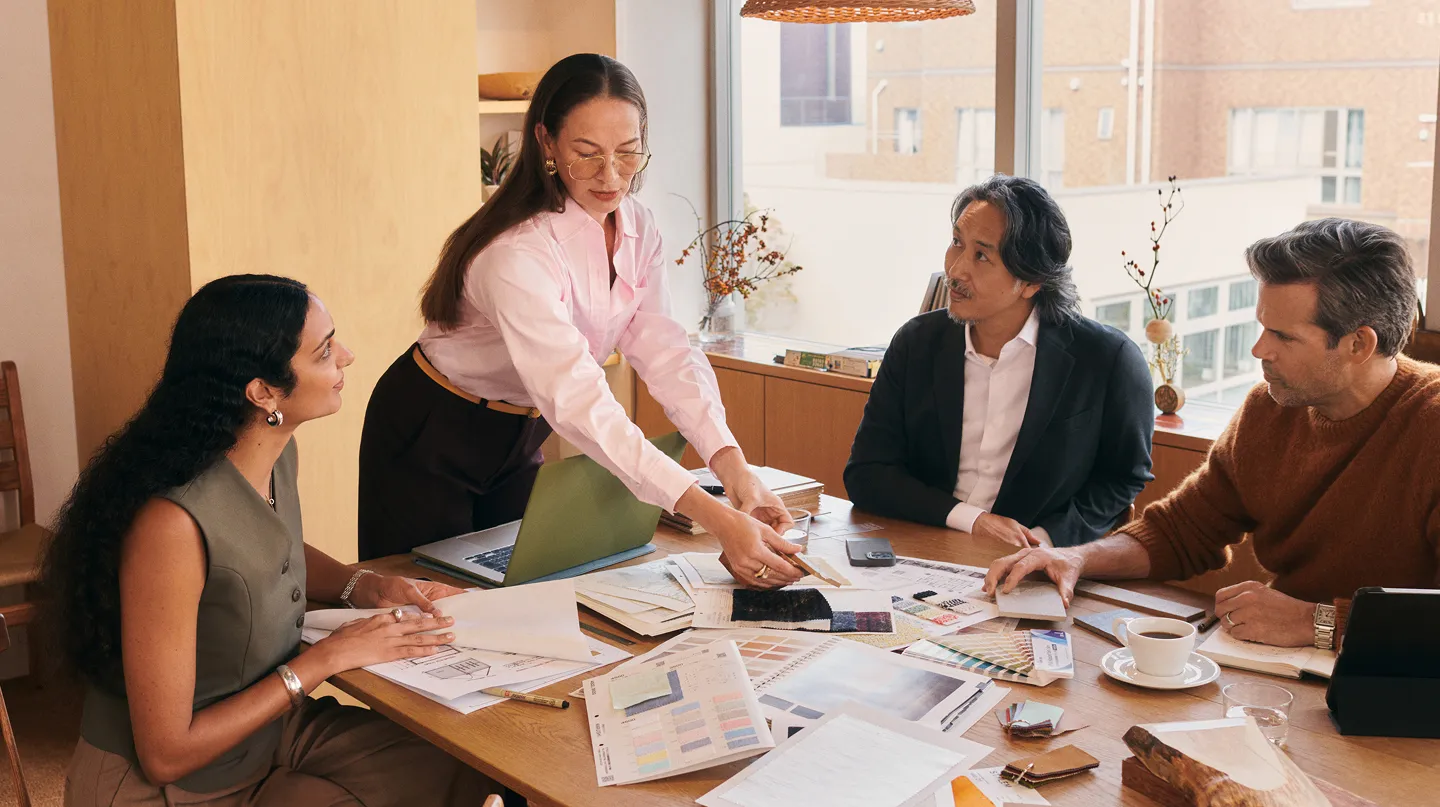 A team of women and men having a collaborative meeting in a conference room
